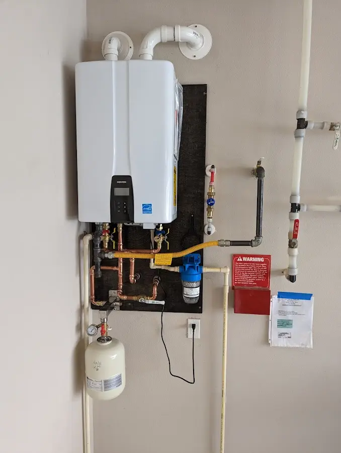 Professional plumber installing copper piping in a Roswell home